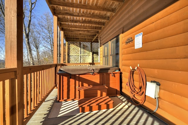 wooden deck with a hot tub