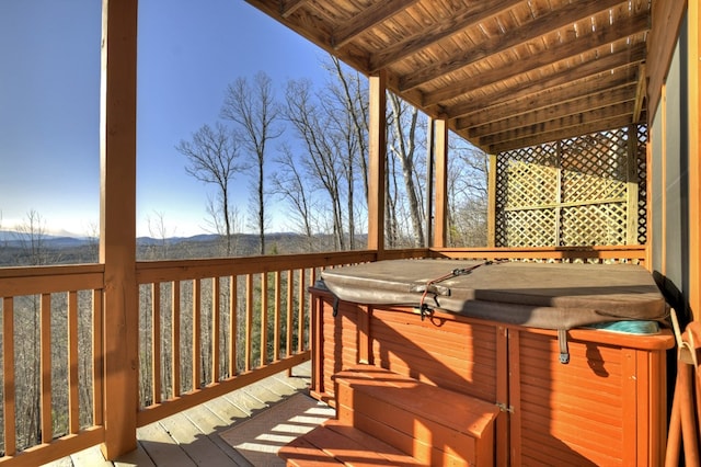 wooden terrace with a mountain view and a hot tub