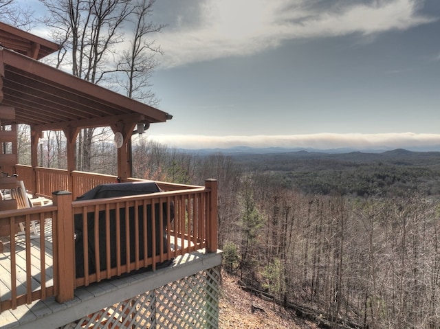 wooden deck with a mountain view and a wooded view