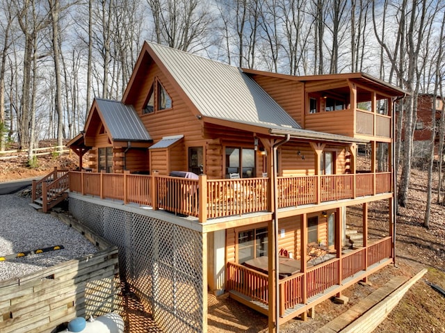 exterior space with metal roof and a deck