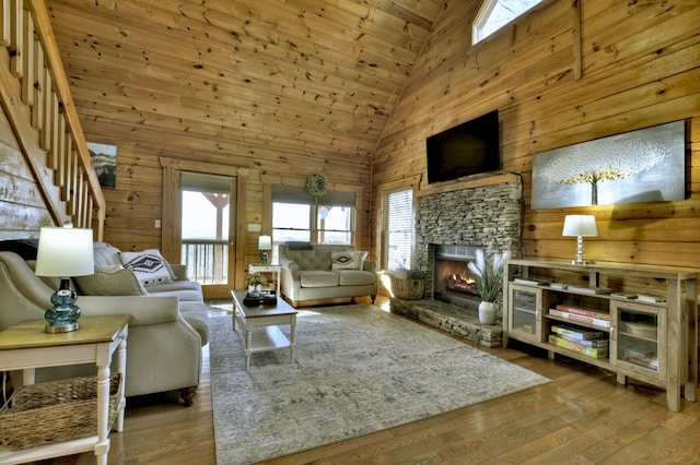 living room with wood walls and a healthy amount of sunlight