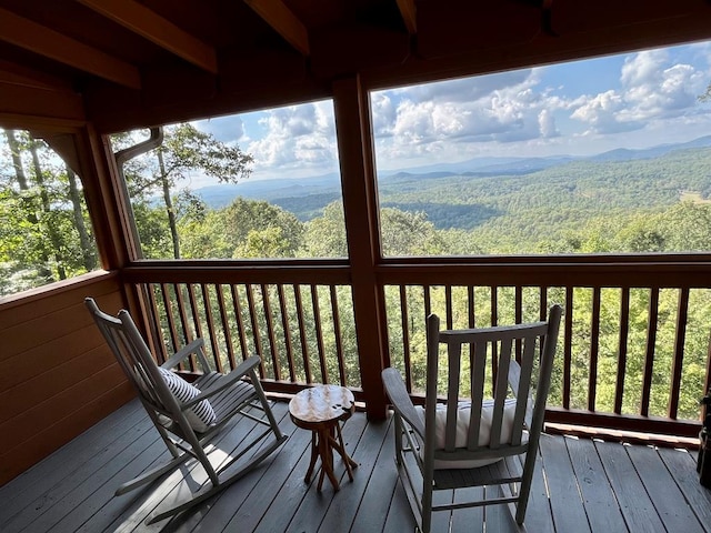 deck with a mountain view and a wooded view