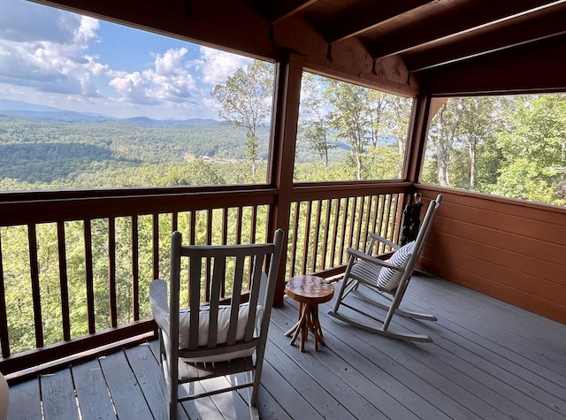 wooden terrace with a mountain view and a wooded view