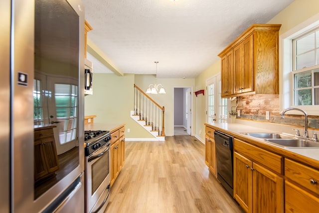 421 Burgess Rd, Ellijay, GA 30540 - kitchen featuring a sink, appliances with stainless steel finishes, light wood-type flooring, a chandelier, and light countertops