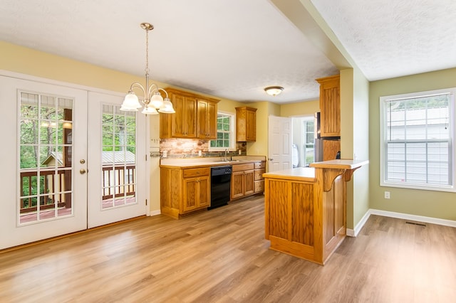 421 Burgess Rd, Ellijay, GA 30540 - kitchen with black dishwasher, a sink, light countertops, light wood-type flooring, and a textured ceiling