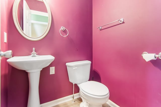 421 Burgess Rd, Ellijay, GA 30540 - half bathroom featuring toilet, baseboards, and a sink
