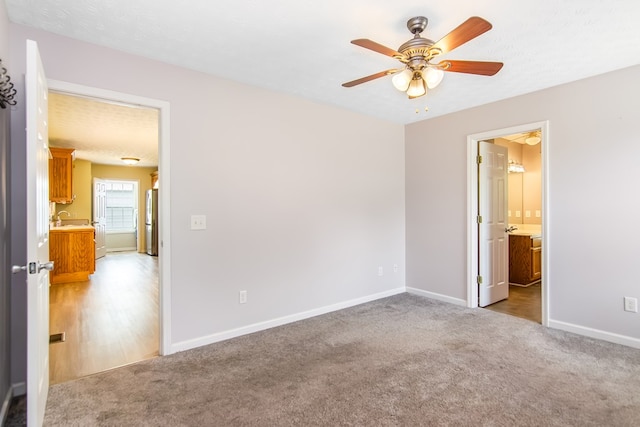 421 Burgess Rd, Ellijay, GA 30540 - unfurnished bedroom with freestanding refrigerator, light colored carpet, baseboards, and connected bathroom