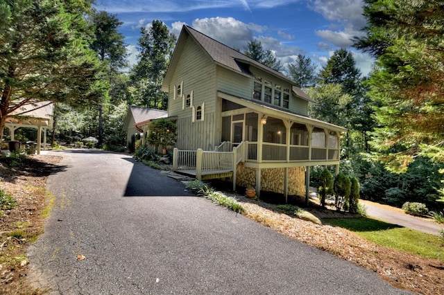 view of front of property with a sunroom and aphalt driveway