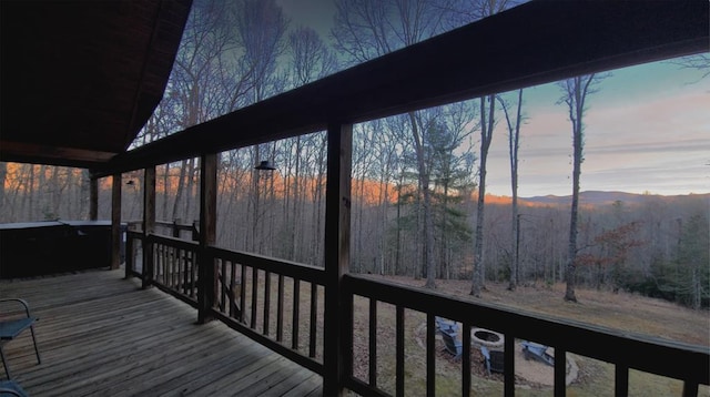 wooden terrace with a wooded view