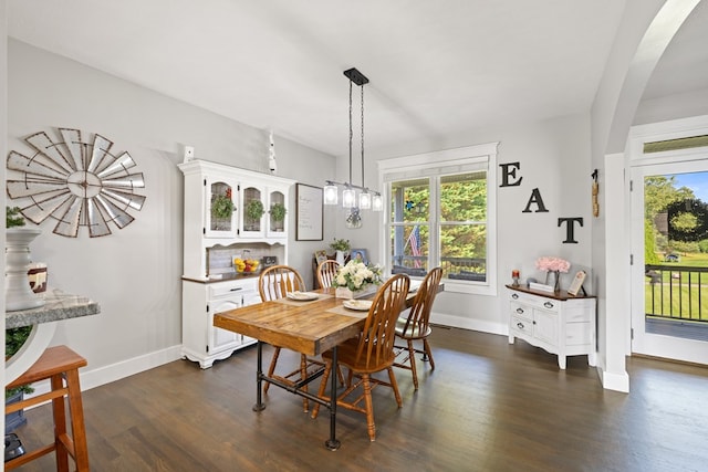 429 Sneaking Creek Dr, Hayesville, NC 28904 - dining area featuring dark wood-type flooring, baseboards, arched walkways, and a chandelier