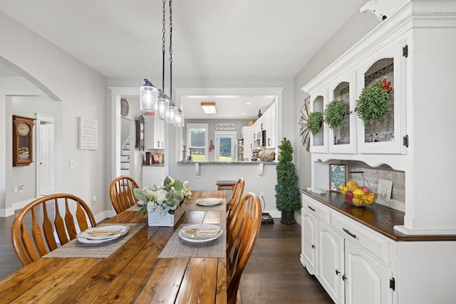 429 Sneaking Creek Dr, Hayesville, NC 28904 - dining space featuring stairway, arched walkways, dark wood-style floors, and baseboards