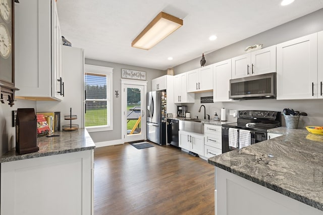 429 Sneaking Creek Dr, Hayesville, NC 28904 - kitchen featuring black appliances, a sink, dark wood-style floors, white cabinets, and dark stone counters