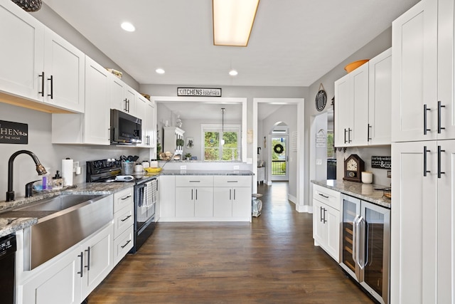 429 Sneaking Creek Dr, Hayesville, NC 28904 - kitchen featuring black appliances, beverage cooler, dark wood-type flooring, recessed lighting, and light stone counters