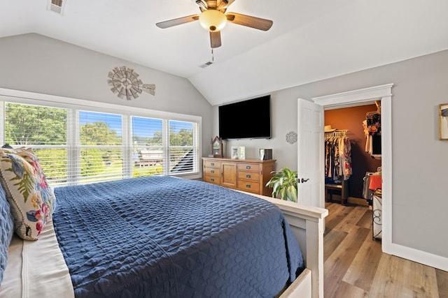 429 Sneaking Creek Dr, Hayesville, NC 28904 - bedroom featuring vaulted ceiling, a spacious closet, light wood-type flooring, a ceiling fan, and baseboards