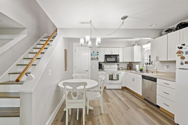 429 Sneaking Creek Dr, Hayesville, NC 28904 - kitchen featuring white appliances, a sink, white cabinets, light wood finished floors, and light countertops