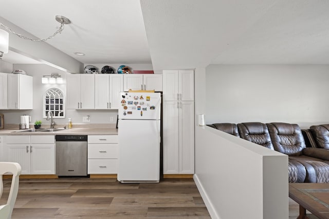 429 Sneaking Creek Dr, Hayesville, NC 28904 - kitchen with stainless steel dishwasher, freestanding refrigerator, a sink, open floor plan, and wood finished floors