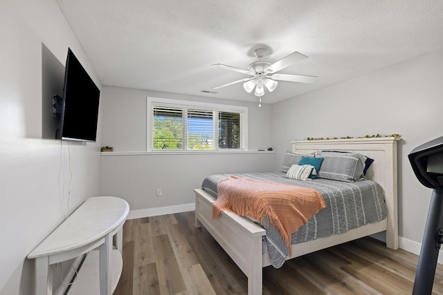 429 Sneaking Creek Dr, Hayesville, NC 28904 - bedroom with wood finished floors, baseboards, a textured ceiling, and ceiling fan