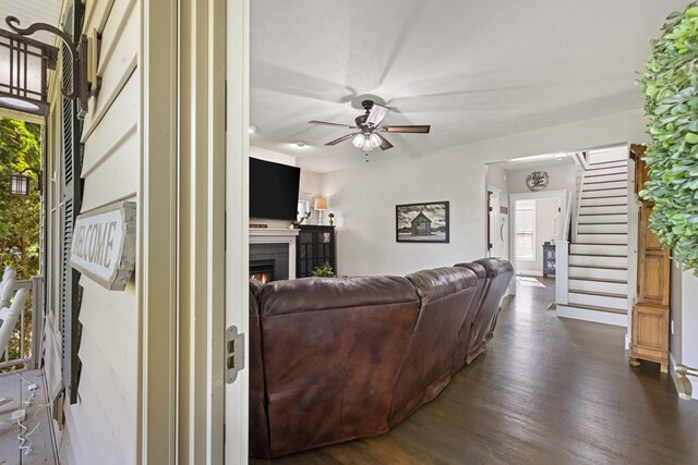 429 Sneaking Creek Dr, Hayesville, NC 28904 - living area featuring a lit fireplace, dark wood finished floors, a ceiling fan, stairs, and baseboards