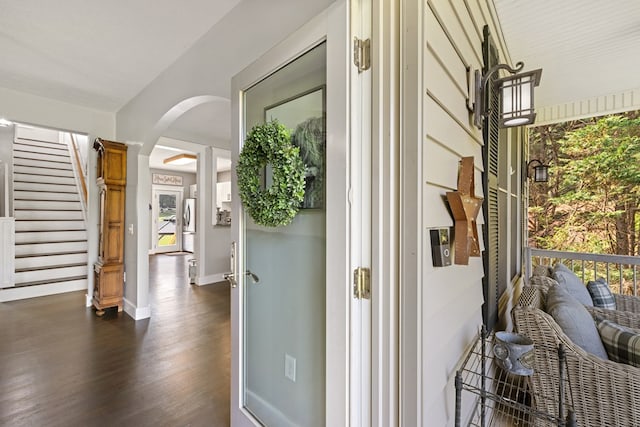 429 Sneaking Creek Dr, Hayesville, NC 28904 - hallway featuring arched walkways, dark wood-style flooring, baseboards, ornate columns, and stairway