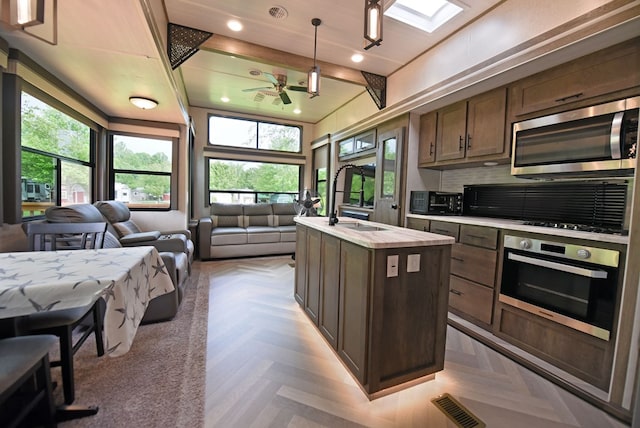 201 Kole Dr, Blairsville, GA 30512 - kitchen with stainless steel appliances, open floor plan, a sink, light countertops, and recessed lighting