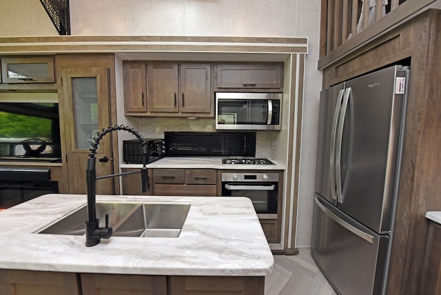 201 Kole Dr, Blairsville, GA 30512 - kitchen featuring stainless steel appliances, a sink, decorative backsplash, and dark brown cabinets