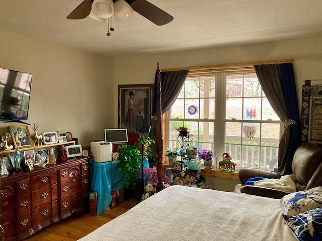 bedroom featuring hardwood / wood-style floors and ceiling fan