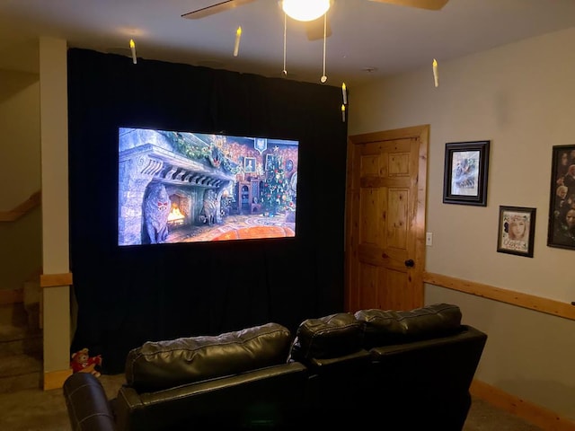 carpeted cinema room with ceiling fan