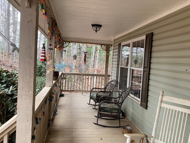 wooden terrace featuring covered porch