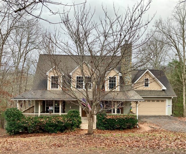 view of front facade featuring a porch and a garage