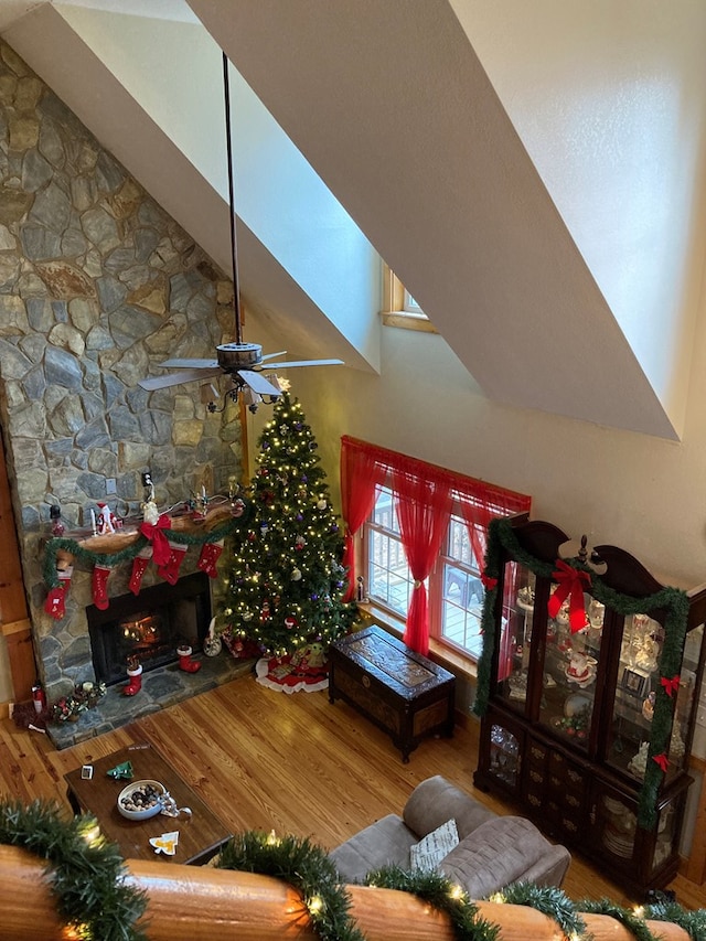 living room with ceiling fan, a fireplace, and hardwood / wood-style flooring