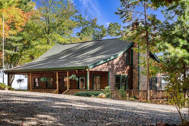 log-style house with covered porch