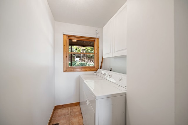 washroom featuring cabinets, independent washer and dryer, light tile patterned flooring, and a textured ceiling