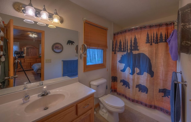 full bathroom featuring vanity, ceiling fan, toilet, and shower / bathtub combination with curtain