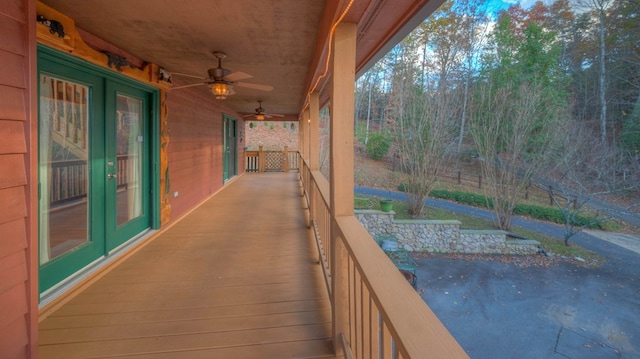 wooden deck with ceiling fan and french doors