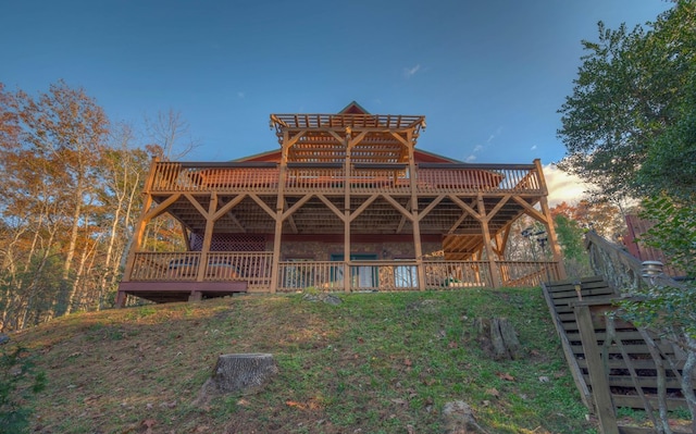 back house at dusk with a deck