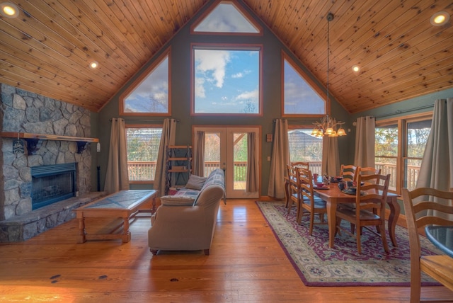 living room featuring wood-type flooring, a healthy amount of sunlight, and high vaulted ceiling