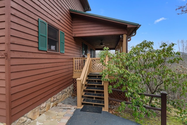 exterior space with stairway and a ceiling fan
