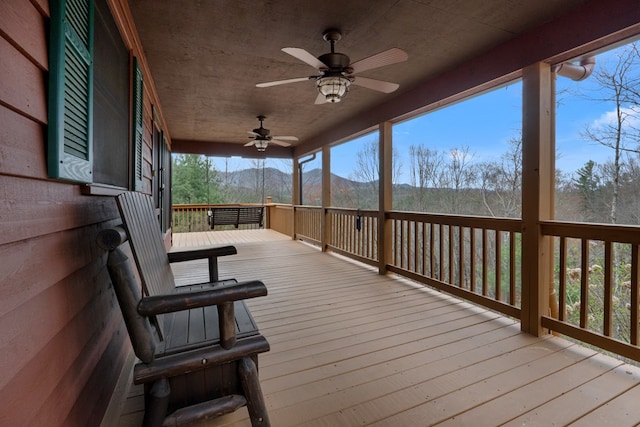 deck with a mountain view and a ceiling fan