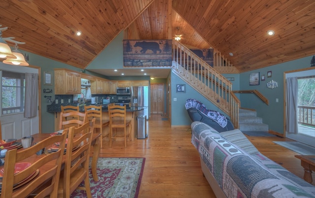 living room with wooden ceiling, light hardwood / wood-style floors, and high vaulted ceiling