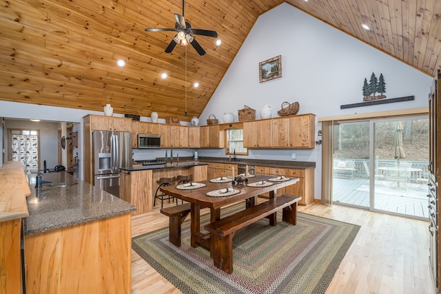 dining space with light wood-type flooring, wood ceiling, and high vaulted ceiling