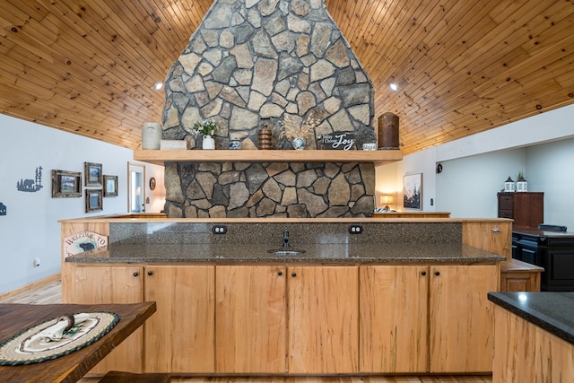 kitchen featuring dark stone countertops, high vaulted ceiling, wooden ceiling, and a peninsula