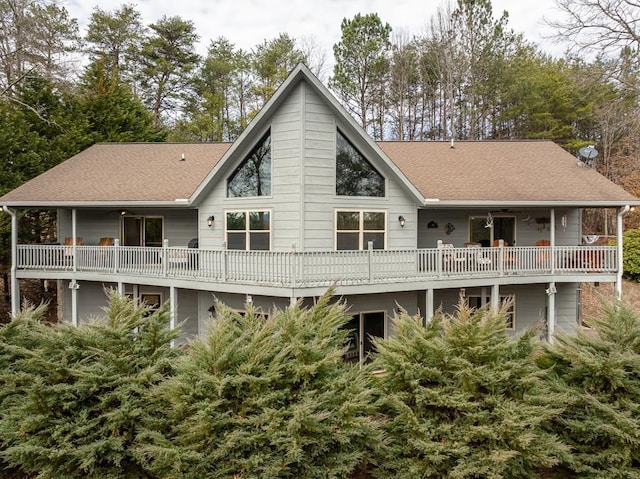 rear view of property featuring a shingled roof