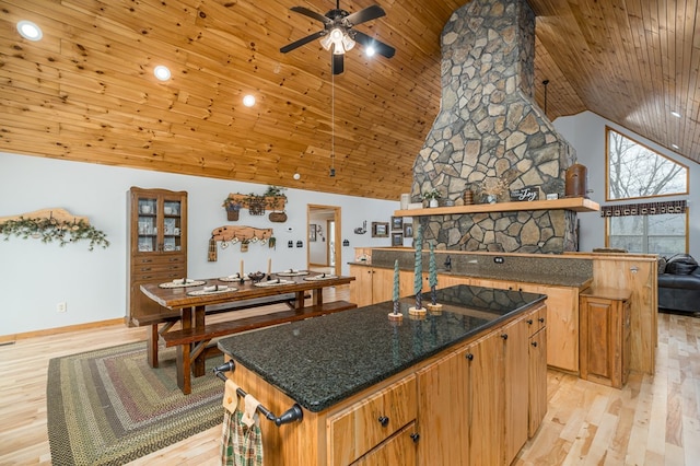 kitchen featuring a center island, open shelves, a ceiling fan, light wood-type flooring, and wooden ceiling