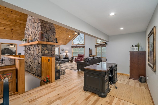 office with lofted ceiling, wooden ceiling, wood finished floors, a stone fireplace, and recessed lighting