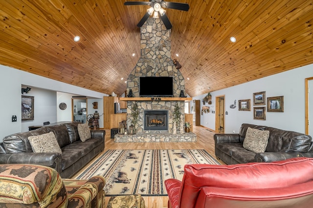 living area with high vaulted ceiling, a stone fireplace, wooden ceiling, and wood finished floors