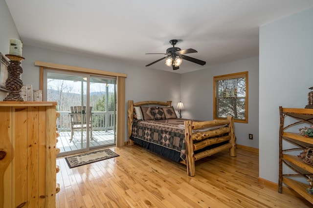 bedroom featuring access to exterior, light wood-style flooring, baseboards, and ceiling fan