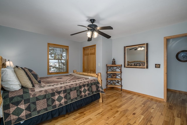 bedroom with baseboards, a ceiling fan, and light wood-style floors