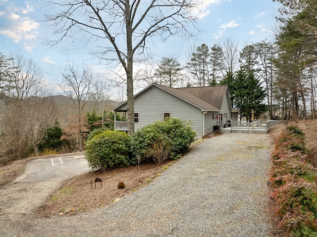 view of side of home featuring driveway