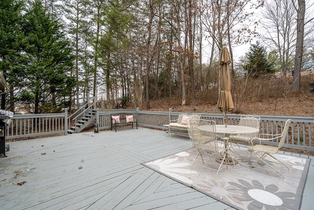 wooden terrace featuring outdoor dining space