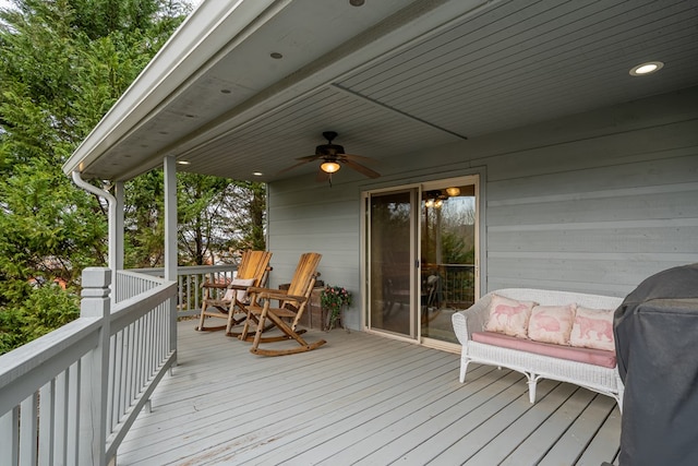 wooden terrace featuring a grill and a ceiling fan